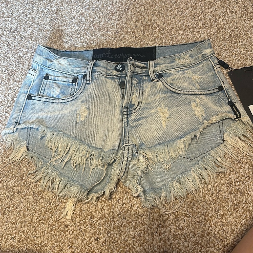 NWT! Cheeky, medium rise, button fly, raw hem, “one teaspoon” brand denim shorts
